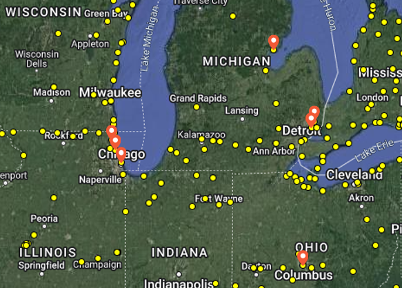 Yellow dots scatter across a map of the Great Lakes region, representing Motus Wildlife Tracking system receiver tower locations. Orange markers on the map show Audubon Great Lakes receiver locations in Michigan, Illinois, and Ohio. 