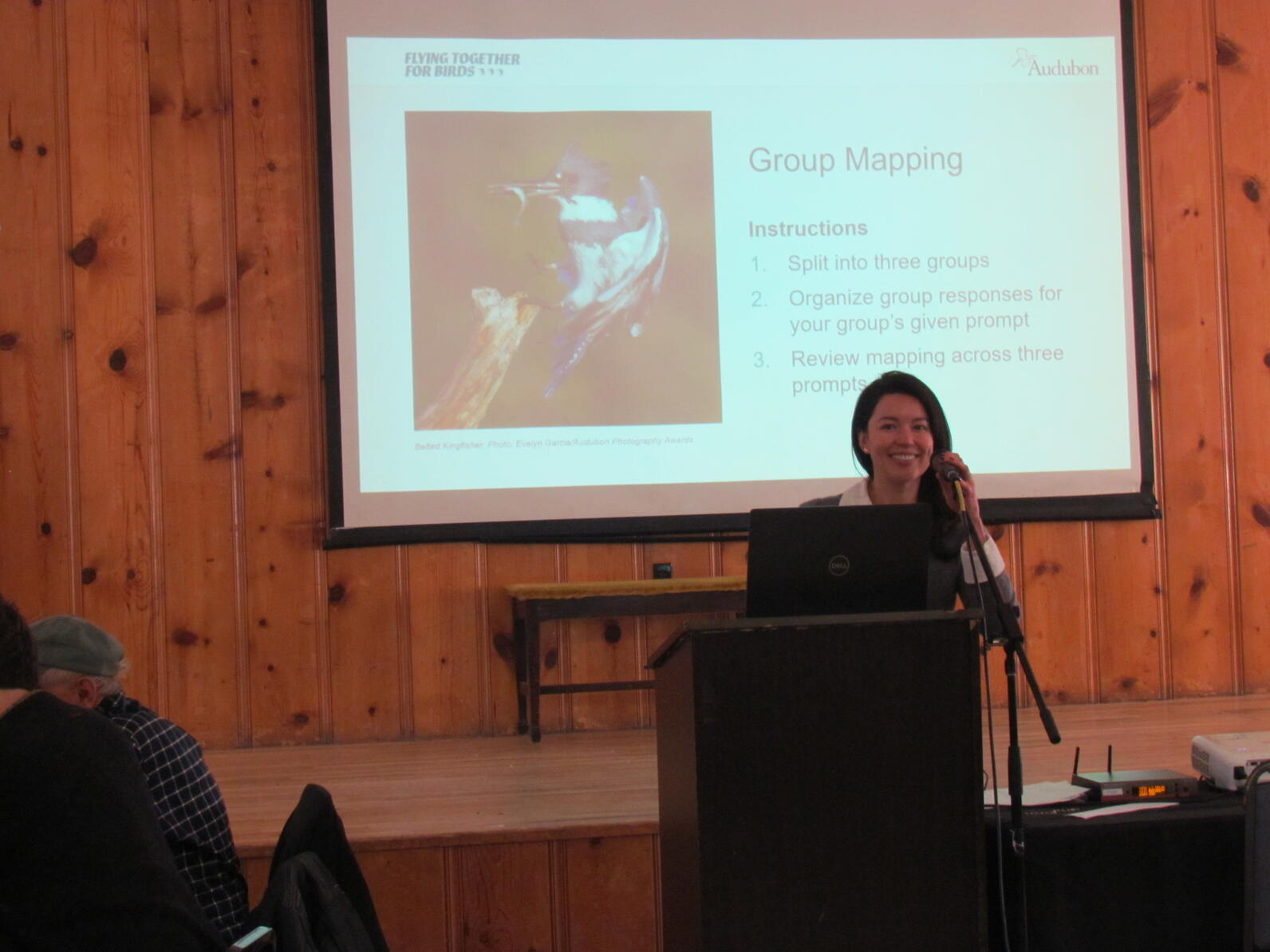 Izabela Grobelna, Engagement Manager with Audubon Great Lakes, stands and smiles at a podium as she facilitates a workshop at the Audubon Leadership Conference.